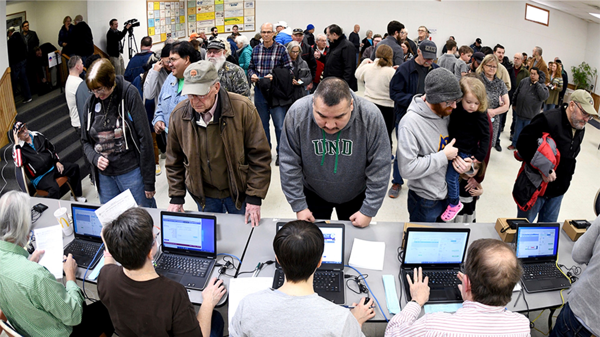 Caucus voters standing in line to register before voting at the North Dakota Democratic NPL Presidential Caucus inside the AFL-CIO House of Labor in Bismarck, N.D.