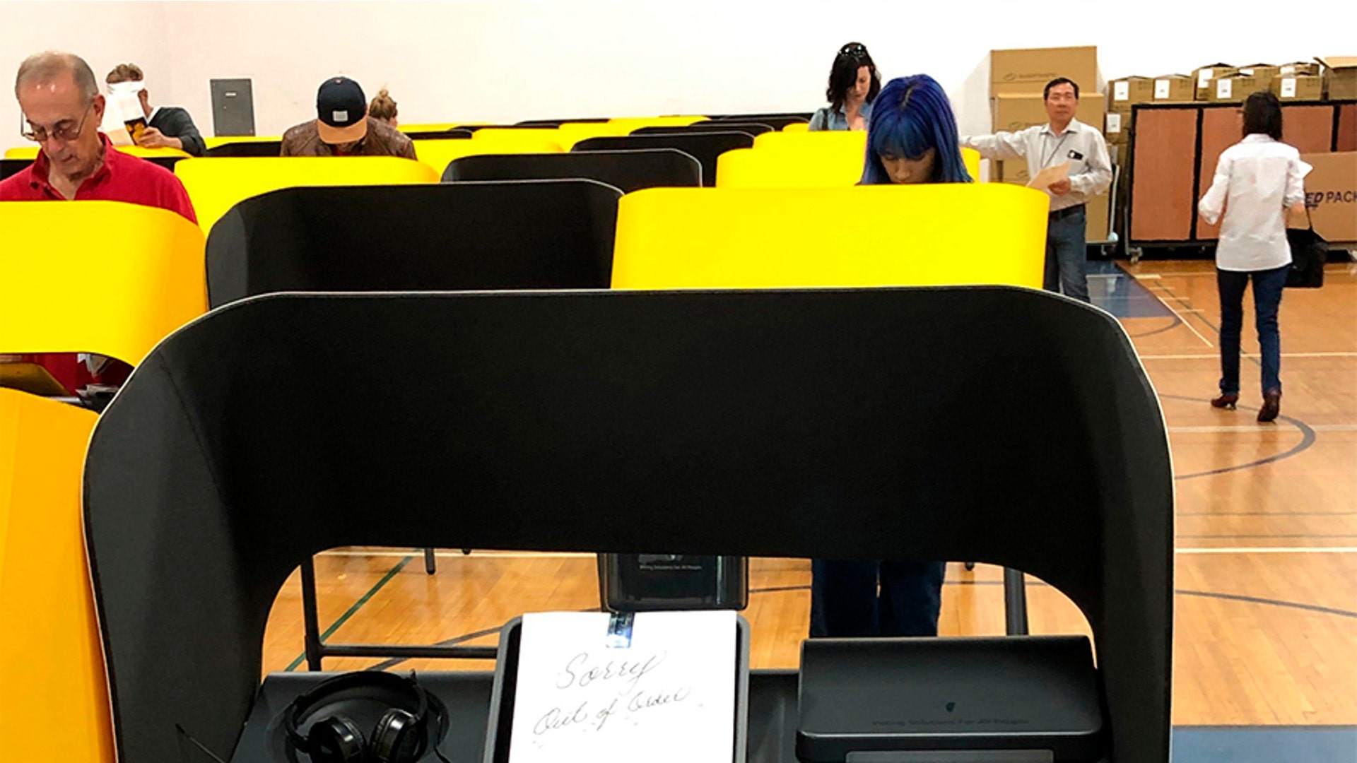 A sign reads "Sorry, Out of Order," on a voting station as people cast the ballots Tuesday, March 3, 2020, at the Silverlake Independent Jewish Community Center in Los Angeles. 