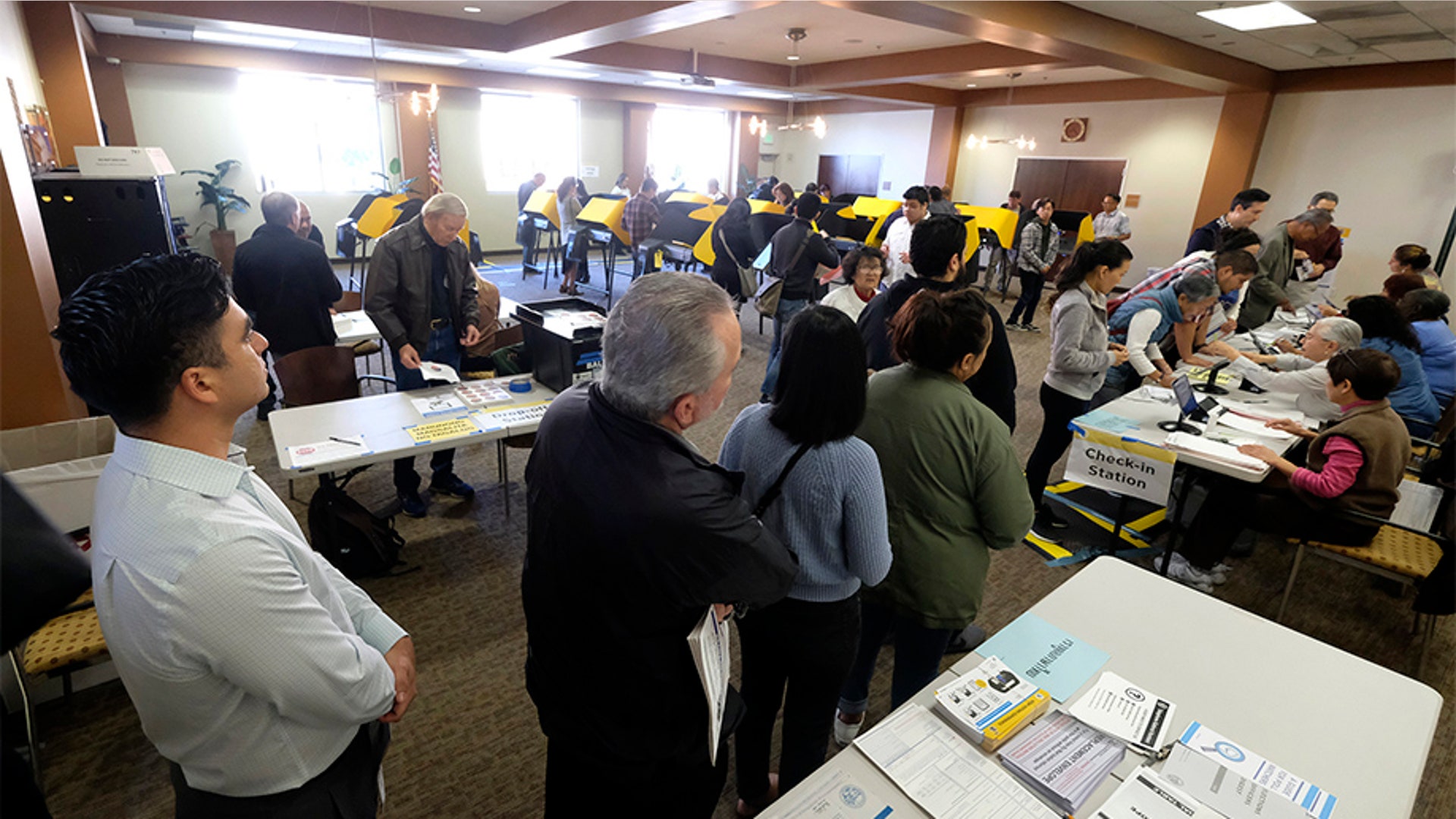 Voters wait in line to cast their ballot on the Super Tuesday, at a voting center in Alhambra, Calif. 