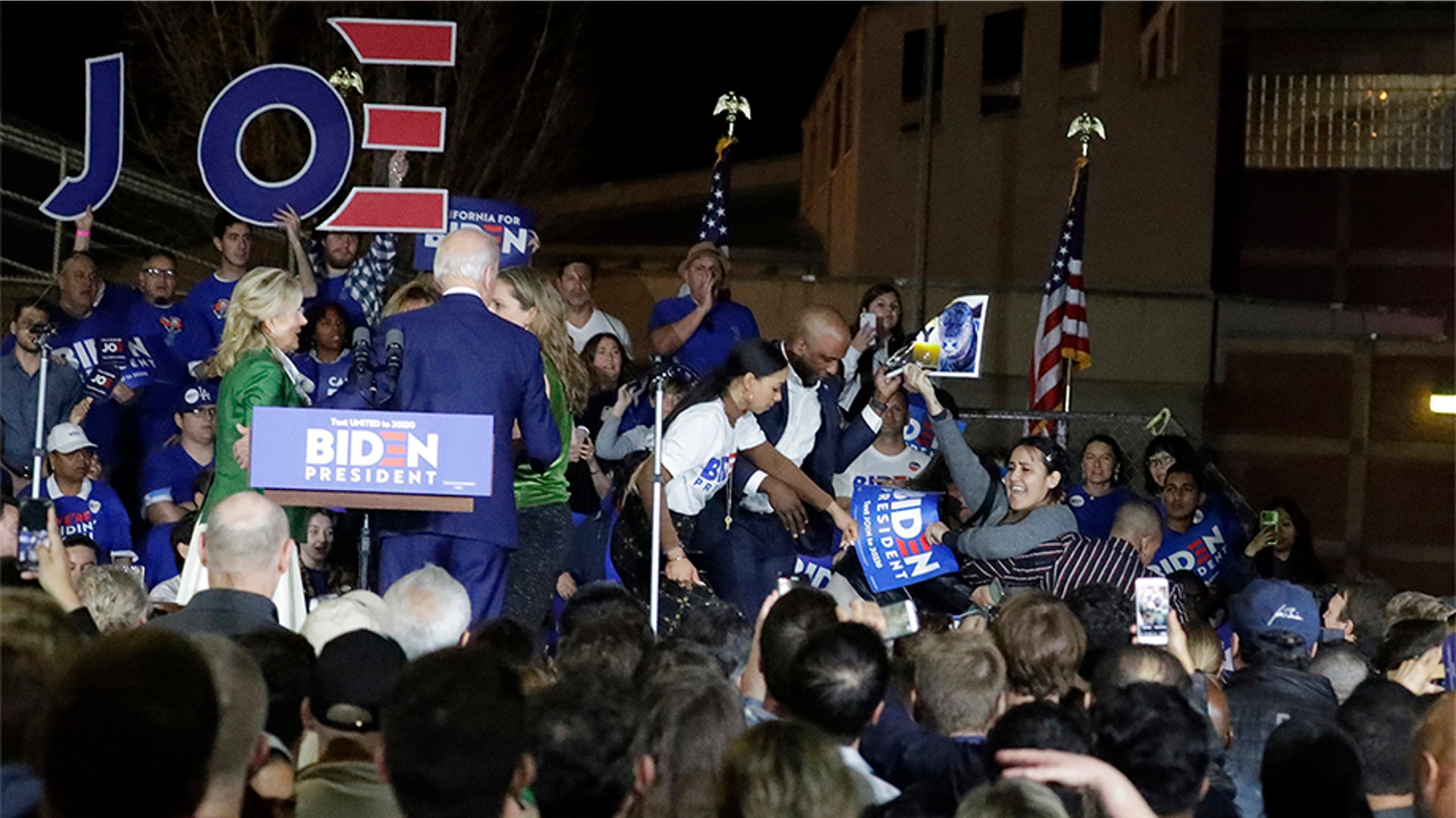 Demonstrators are removed from the stage as Joe Biden speaks at a primary election night campaign rally, in Los Angeles. 