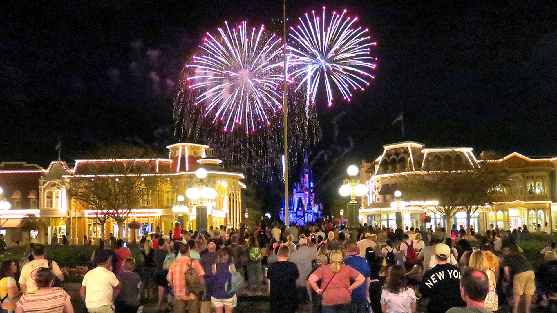 Guests gather on Main Street USA, in the Magic Kingdom at Walt Disney World, to watch fireworks before the park closed, Sunday night, March 15, 2020, in Lake Buena Vista, Fla. Walt Disney World announced that all their parks will be closed for the rest of March as a result of the coronavirus pandemic.