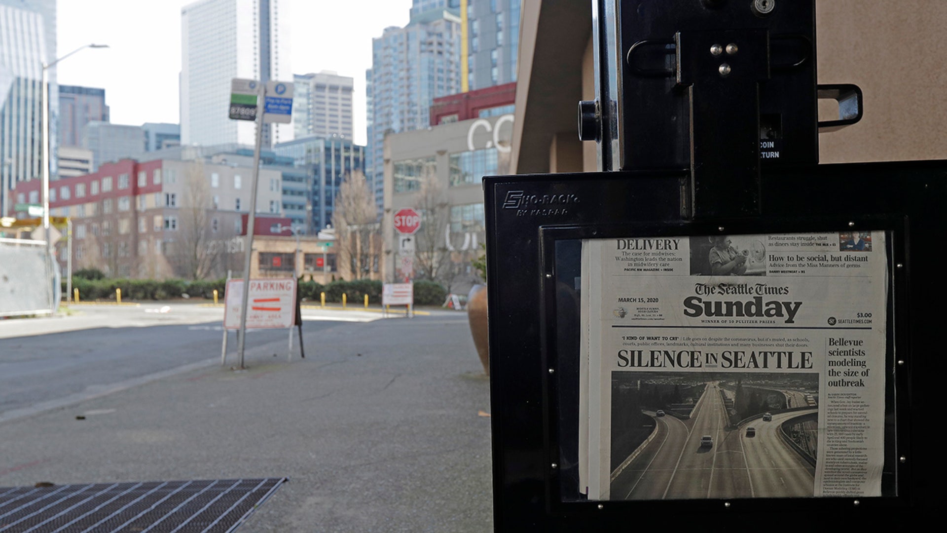 The street next to a Seattle Times newspaper box in front of the building that houses the Times' newsroom is empty, Sunday, March 15, 2020 in Seattle, as the headline "Silence in Seattle" is displayed. Washington Gov. Jay Inslee said Sunday night that he would order all bars, restaurants, entertainment and recreation facilities in the state to temporarily close to fight the spread of coronavirus, as Washington state has by far the most deaths in the U.S. from the disease.