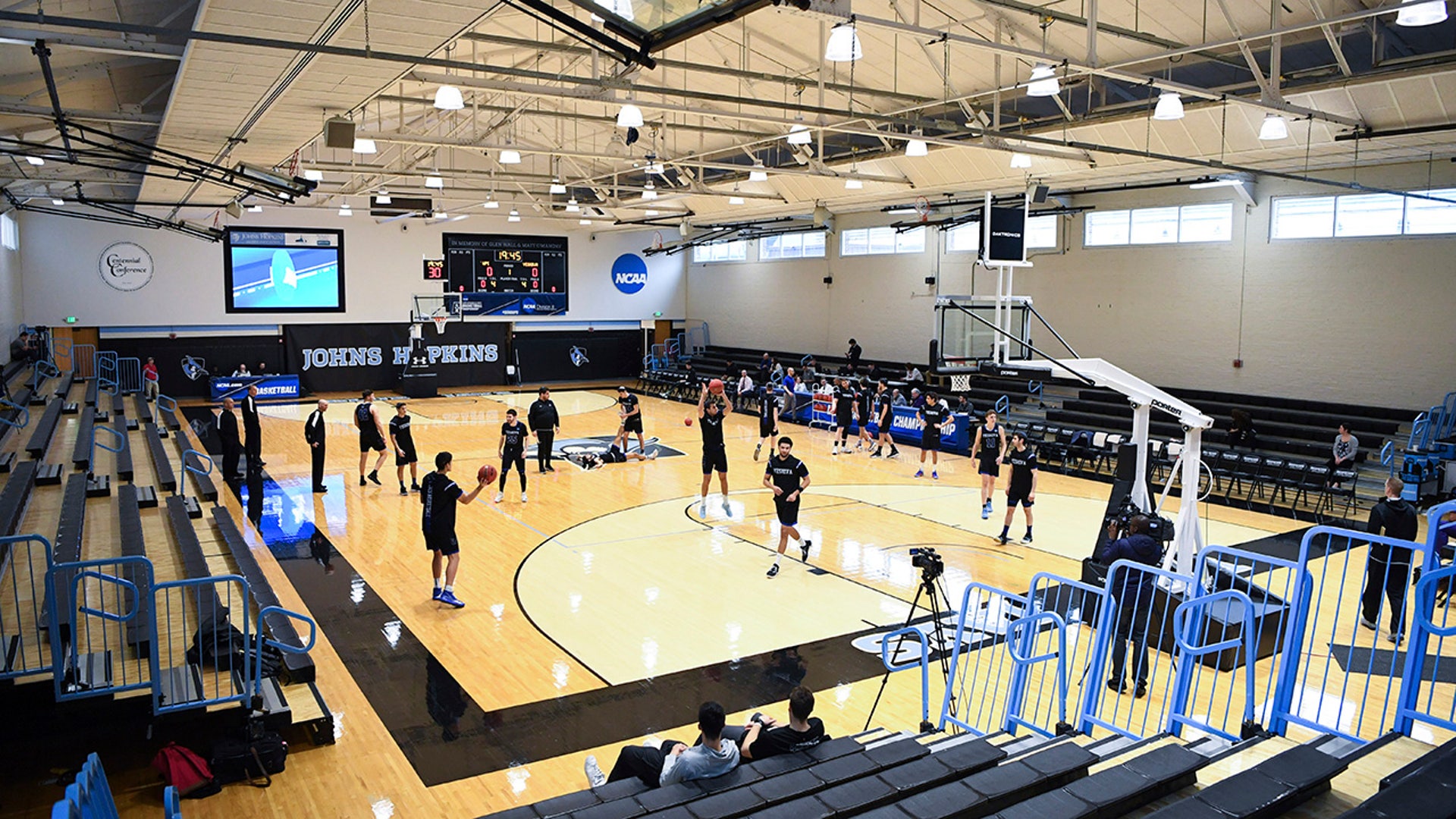 Yeshiva and Worcester Polytechnic Institute players warm up before an NCAA DIII college basketball game that allowed no spectators on Friday, March 6, 2020, in Baltimore, Md. The game at Johns Hopkins University is believed to be the first U.S. sports event held without fans because of the new coronavirus.
