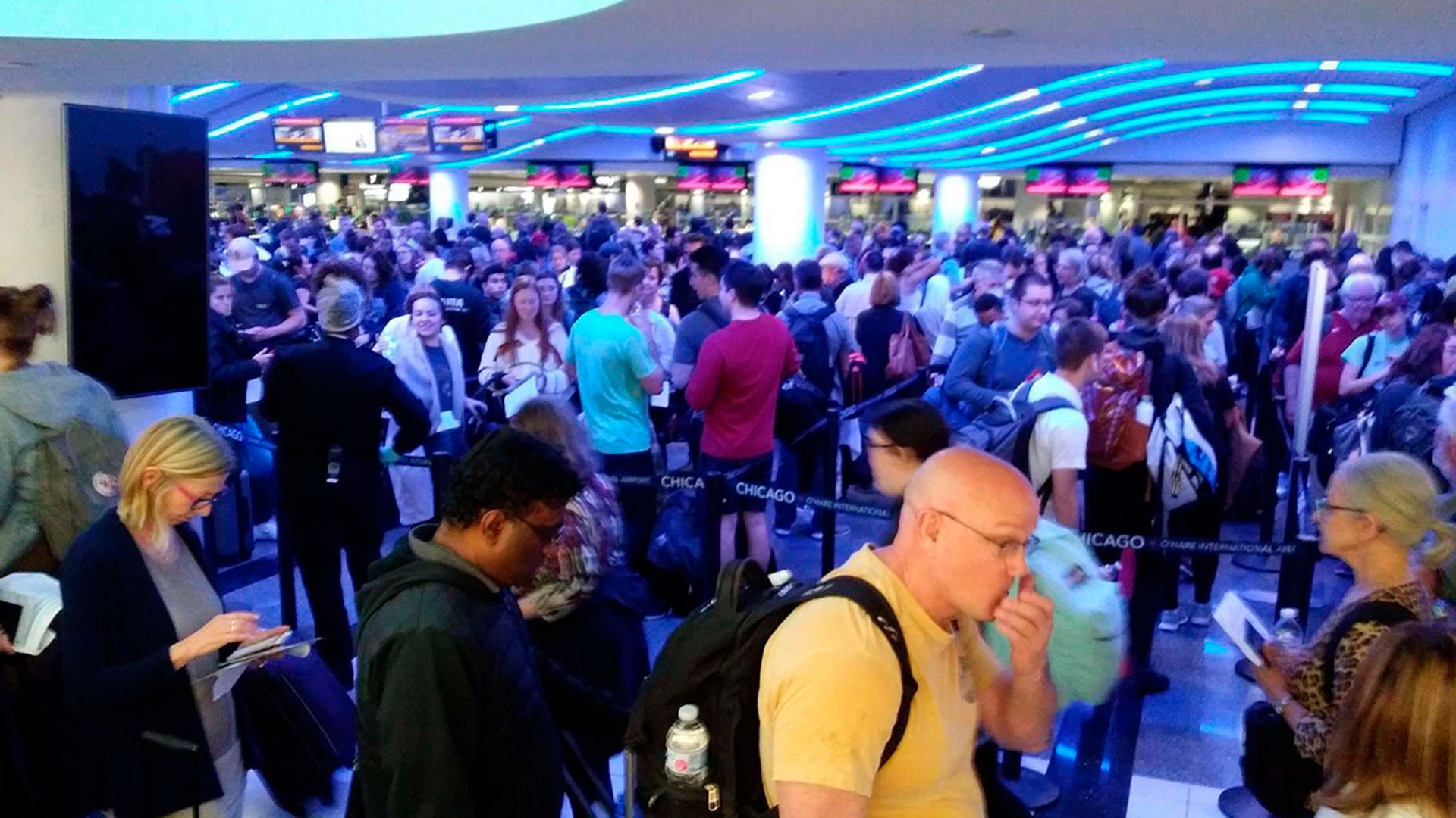 Travelers wait in line to go through customs at O'Hare International Airport in Chicago. Chicago Mayor Lori Lightfoot lambasted the administration for allowing about 3,000 Americans returning from Europe to be stuck for hours inside the customs area at O'Hare International Airport on Saturday, violating federal recommendations from the Centers for Disease Control and Prevention that people practice “social distancing."