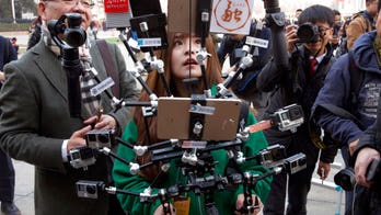 China takes aim at 4 US media companies, demanding staff, business info