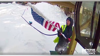 Veteran's security camera catches propane deliveryman trudging through snow to fix fallen flag