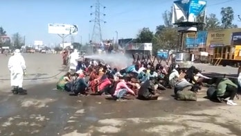 Coronavirus lockdown in India spurs probe after migrant workers sprayed with 'chemical solution'