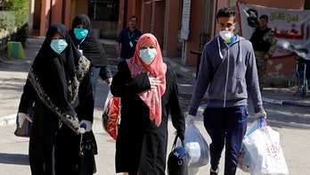 Iraqis protest burying coronavirus dead, defy government and gather for mass pilgrimage