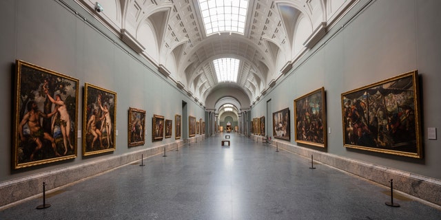 View of an empty gallery at El Prado Museum in Madrid, Spain, Thursday, March 12, 2020. The spread of the new coronavirus continues disrupting normal life in parts of Spain, and it's also affecting sports, cultural and all sorts of leisure events after the government imposed a ban on gatherings of more than 1,000 people and to cut to a third the maximum audience of all venues holding indoor sports or cultural events. (AP Photo/Bernat Armangue)