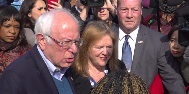Sen. Bernie Sanders and his wife Jane, surrounded by reporters, arrive to vote on Super Tuesday at a polling station in Burlington, Vermont on March 3, 2020