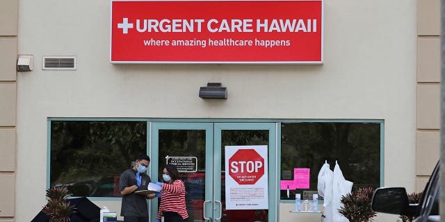 People wearing medical gear stand outside an Urgent Care Hawaii medical clinic March 13, 2019, in Pearl City, Hawaii. (Associated Press)