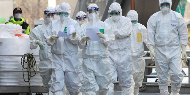Medical staff members arrive for a duty shift at Dongsan Hospital in Daegu, South Korea, Tuesday, March 24, 2020.