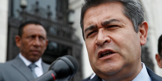Honduran President Juan Orlando Hernandez answers questions from the Associated Press, as he leaves a meeting at the Organization of American States, in Washington. U.S. prosecutors said on Tuesday that Hernandez met with a Honduran drug dealer in 2013 and agreed to facilitate the use of Honduran armed forces personnel as security for the dealer’s drug trafficking activities. (AP Photo/Jacquelyn Martin, File)