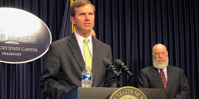 Kentucky Gov. Andy Beshear discusses developments in Kentucky regarding the new coronavirus on Friday in Frankfort, Ky. Beshear ordered bars and restaurant dine-in services to close in another aggressive step to contain the new coronavirus as the state reported its first death linked to the illness.(AP Photo/Bruce Schreiner)