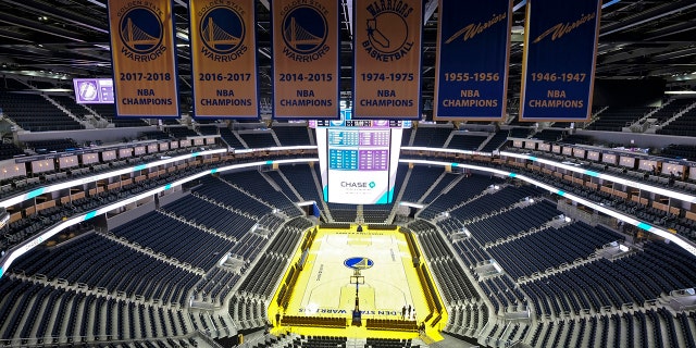 The Golden State Warriors championship banners hang above the seating and basketball court at the Chase Center in San Francisco. The NBA suspended the season Wednesday amid coronavirus fears.