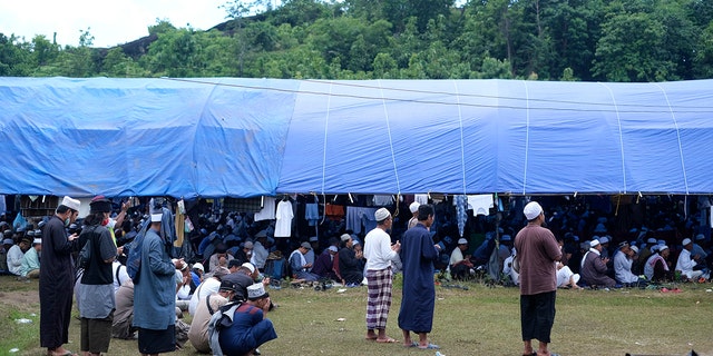 Muslim pilgrims gathered to pray on a field Thursday before the event was shut down. (AP)