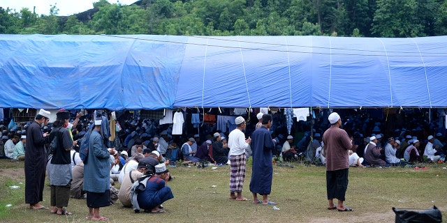 Muslim pilgrims gathered to pray on a field Thursday before the event was shut down. (AP)