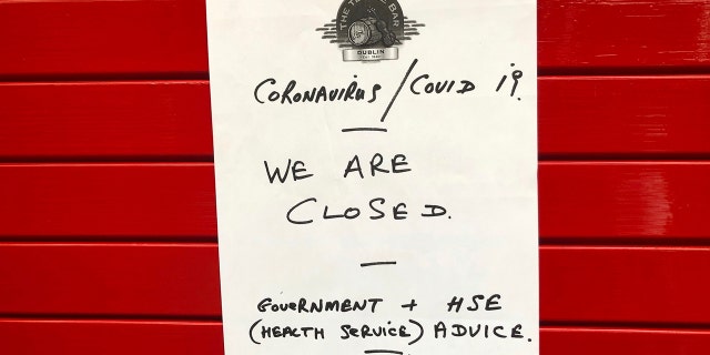 A sign on the door of The Temple Bar announced it would be closed with immediate effect amid coronavirus fears.