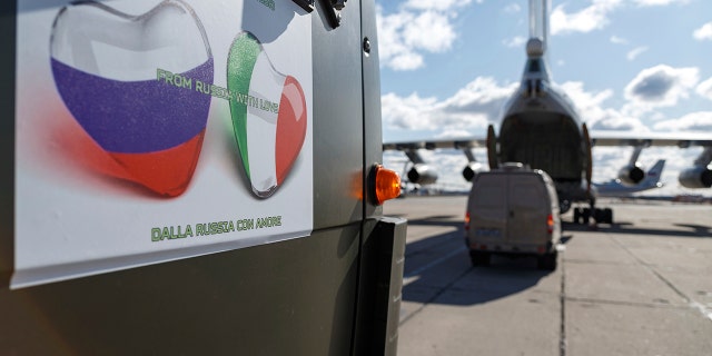 A sign on a Russian military vehicle reads: "From Russia with love" in several languages. (Alexei Yereshko, Russian Defense Ministry Press Service via AP)