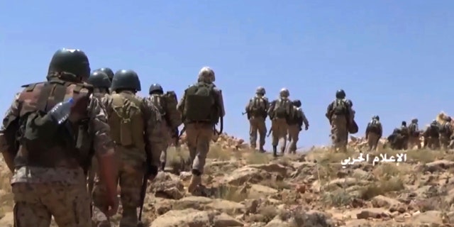 FILE - This file frame grab from video released on July 22, 2017 and provided by the government-controlled Syrian Central Military Media, shows Hezbollah fighters advancing up a hill during clashes with al-Qaida-linked militants in an area on the Lebanon-Syria border. Lebanon's militant Hezbollah group lost at least eight fighters in northwestern Syria in fighting against insurgents and airstrikes by the Turkey's air force following the death of at least 33 Turkish soldiers earlier this week, a Syrian opposition war monitor and the militant group said Saturday. (Syrian Central Military Media, via AP, File)