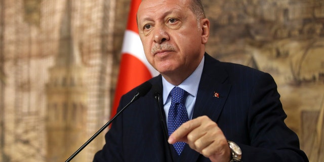 Turkey's President Recep Tayyip Erdogan speaks to his ruling party's lawmakers, in Istanbul, Saturday, Feb. 29, 2020. Erdogan said Saturday that his country's borders with Europe were open, as thousands of refugees gathered at the frontier with Greece.(Presidential Press Service via AP, Pool)