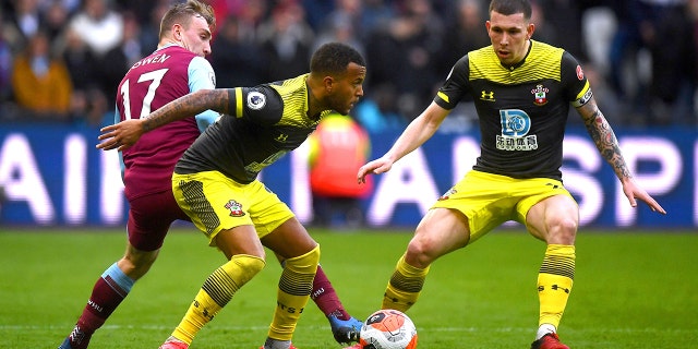 West Ham United's Jarrod Bowen, left, battles for the ball against Southampton's Ryan Bertrand, center, and Pierre-Emile Hojbjerg during their English Premier League soccer match at London Stadium, in London, Saturday, Feb. 29, 2020. (Victoria Jones/PA via AP)