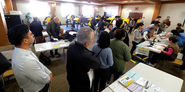Voters wait in line to cast their ballot on the Super Tuesday, at a voting center in Alhambra, Calif., Tuesday, March 3, 2020.