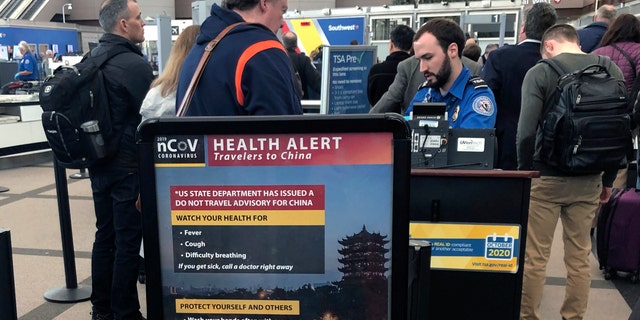 In this Monday, March 2 photo, a health alert for people traveling to China is shown at a TSA security checkpoint at the Denver International Airport. (AP Photo/Charles Rex Arbogast, File)