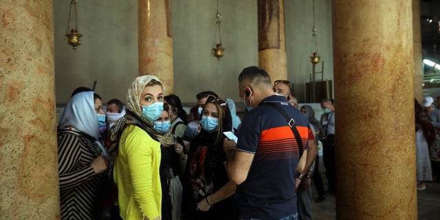 People visit the Church of the Nativity in Bethlehem, West Bank, Thursday, March 5, 2020. Palestinian authorities said the Church of the Nativity in Bethlehem, built atop the spot where Christians believe Jesus was born, will close indefinitely due to coronavirus concerns.