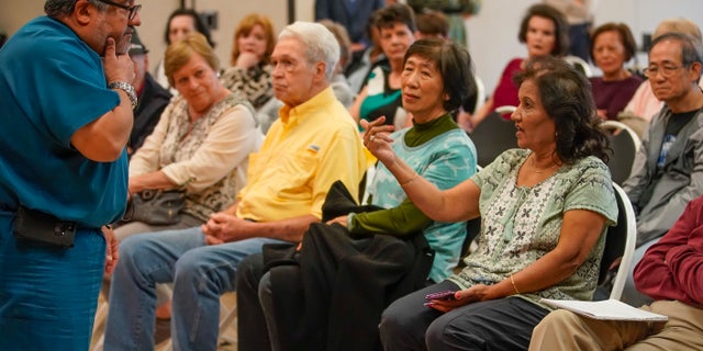 A full meeting room of seniors listen as Dr. Joe A. Anzaldua, the local health authority for the city of Sugar Land, talks about how they can better prepare themselves against coronavirus Thursday, March 5, 2020, at T.E. Harman Center in Sugar Land, Texas. The center for senior adults 50 years of age and older held the meeting with county health officials in response to the recent news of a 70-year-old man in Fort Bend county said to have COVID-19.