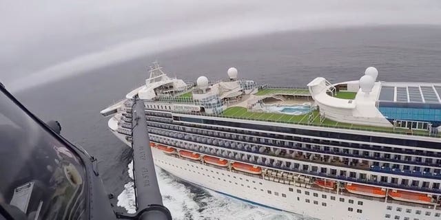 In this image from video, provided by the California National Guard, a helicopter carrying airmen with the 129th Rescue Wing flies over the Grand Princess cruise ship off the coast of California Thursday, March 5, 2020.