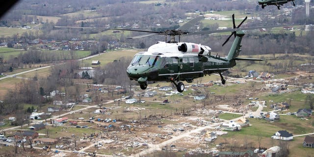 Marine One, with President Donald Trump aboard, left, flies over damage after a recent tornado, Friday, March 6, 2020, taken on the plane in flight over Cookeville, Tenn. (AP Photo/Alex Brandon)