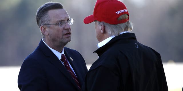 President Donald Trump greets Rep. Doug Collins, R-Ga., as he arrives on Air Force One Friday, March 6, 2020, at Dobbins Air Reserve Base in Marietta, Ga. (AP Photo/Alex Brandon)