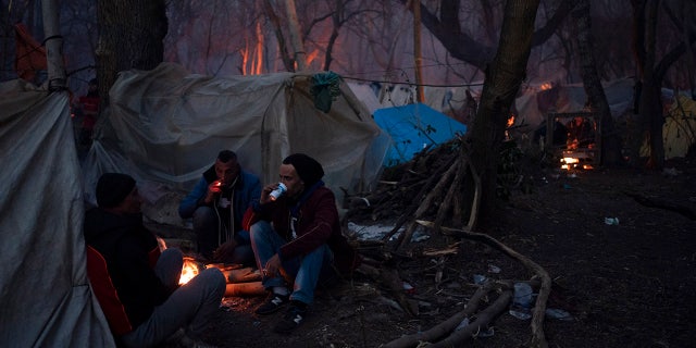 Migrants gather at a makeshift camp near the Pazarkule border gate at the Turkish-Greek border in Edirne region, on Saturday, March 7, 2020. A group of migrants on Saturday tried to bring down a fence in a desperate attempt to bust through the border into Greece while others hurled rocks at Greek police. Greek authorities responded, firing volleys of tear gas at the youths. (AP Photo/Felipe Dana)