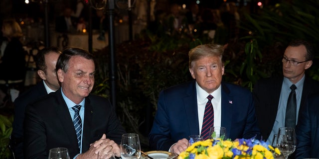 President Donald Trump speaks before a dinner with Brazilian President Jair Bolsonaro, left, at Mar-a-Lago in Palm Beach, Fla. The club alerted its members Monday that the property was being cleaned. (AP Photo/Alex Brandon)