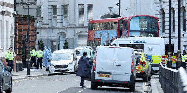 Police activity in Great Scotland Yard, in Whitehall, central London, near the area of an incident, in Whitehall, London, Monday, March 9, 2020. British police say they have shot dead a man who was brandishing two knives near Trafalgar Square in central London. The Metropolitan Police force said Monday that the shooting was not related to terrorism. (Yui Mok/PA via AP)