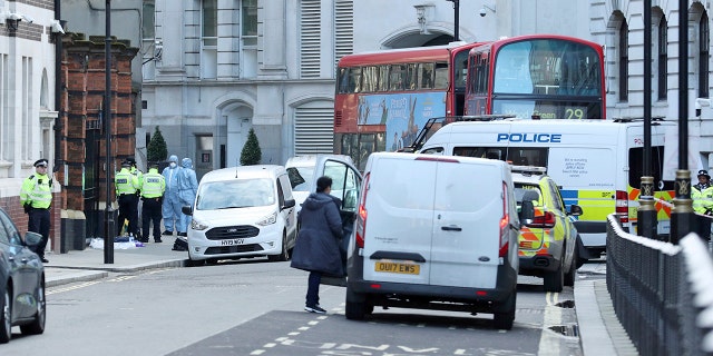 Police activity in Great Scotland Yard, in Whitehall, central London, near the area of an incident, in Whitehall, London, Monday, March 9, 2020. British police say they have shot dead a man who was brandishing two knives near Trafalgar Square in central London. The Metropolitan Police force said Monday that the shooting was not related to terrorism. (Yui Mok/PA via AP)