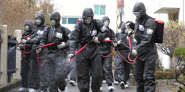 Army soldiers spray disinfectant as a precaution against a new coronavirus at an apartment building in Daegu, South Korea, Monday, March 9, 2020. The world’s largest economies delivered more worrisome cues Monday as anxiety over the virus outbreak sent stock and oil prices plunging around the world.