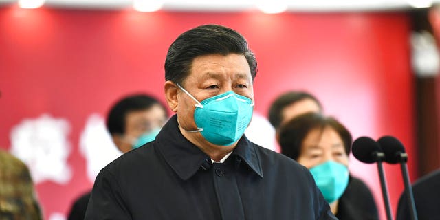 In this photo released by China's Xinhua News Agency, Chinese President Xi Jinping talks by video with patients and medical workers at the Huoshenshan Hospital in Wuhan in central China's Hubei Province, Tuesday, March 10, 2020. 