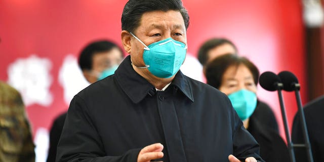 In this photo released by China's Xinhua News Agency, Chinese President Xi Jinping talks by video with patients and medical workers at the Huoshenshan Hospital in Wuhan in central China's Hubei Province, Tuesday, March 10, 2020. 