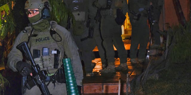 DEA agents search a residential house during an arrest of a suspected drug trafficker on Wednesday, March 11, 2020 in Diamond Bar, California.