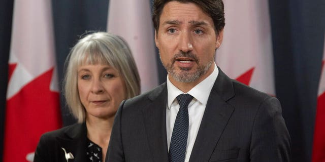 Minister of Health Patty Hajdu looks on as Prime Minister Justin Trudeau speaks during a news conference in Ottawa on, Wednesday March 11, 2020. Canada is announcing $1 billion ($730 million) in funding to help health-care workers cope with the increasing number of new cases of coronavirus and to help Canadian workers who are forced to isolate themselves.