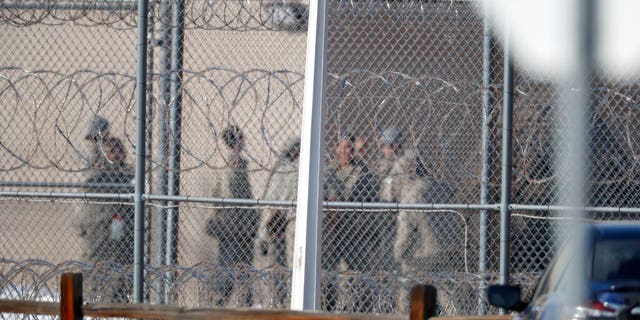 In this Feb. 18, 2020, file photo prisoners stand outside of the federal correctional institution in Englewood, Colorado. (AP Photo/David Zalubowski, File)