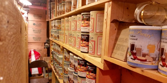 In this undated photo provided by Paul Buescher, canned food rests on shelves in a barn near Garretsville, Ohio. The food can be used by 32 members of a group in northeastern Ohio that shares a farm packed with enough canned and dehydrated food and water to last for years. (Paul Buescher via AP)