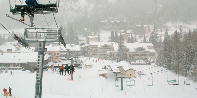 In this Feb. 21, 2008, file photo, skiers ride up Al's Run lift at the Taos Ski Valley, in Taos County, N.M. Some resorts are closing enclosed gondolas or aerial trams while others are encouraging skiers to ride lifts with only people they know as they adhere to social distancing guidelines. (AP Photo/Albuquerque Journal, File)