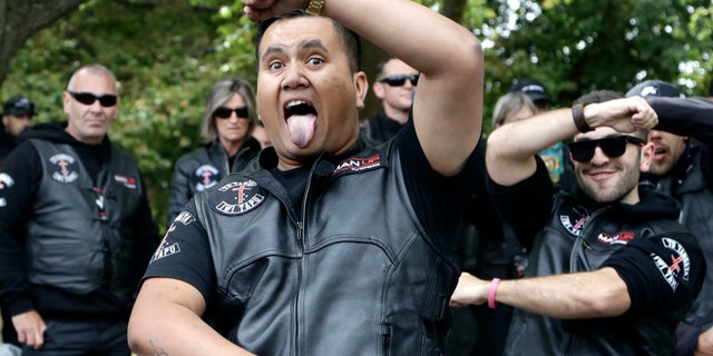 Members of the Tu Tangata motorcycle club perform a haka outside the Al Noor mosque in Christchurch, New Zealand, Sunday, March 15, 2020. A national memorial in New Zealand to commemorate the 51 people who were killed when a gunman attacked two mosques one year ago has been canceled due to fears over the new coronavirus. (AP Photo/Mark Baker)