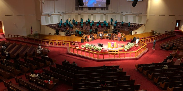 The choir sings during services on at St. Philip African Methodist Episcopal Church in Atlanta on Sunday, March 15, 2020. Only about 100 people filled a sprawling sanctuary that seats more than a thousand at the church because of coronavirus fears. Pastor William Watley told congregants he would follow officials' guidance on whether to continue services after Sunday, calling for prayer during the epidemic. (Jeff Amy/Associated Press)