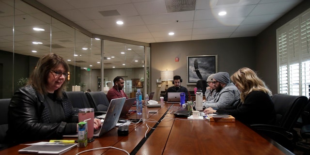 The Bay Church online pastoral team work on their computers during an online church service in Concord, Calif., Sunday, March 15, 2020. (AP Photo/Jeff Chiu)