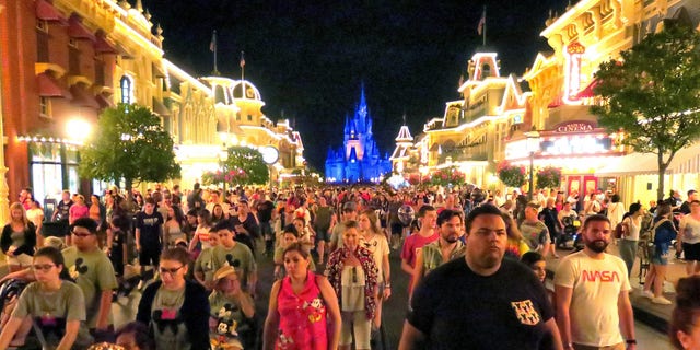 Guests leave the Magic Kingdom at Walt Disney World in the final minutes before the park closed on March 15. Joe Burbank/Orlando Sentinel)