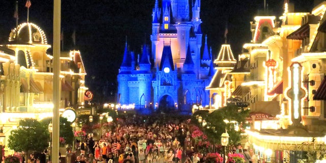 Guests gather on Main Street USA, in the Magic Kingdom at Walt Disney World in the final minutes before the park closed on March 15. (Joe Burbank/Orlando Sentinel)/Orlando Sentinel via AP)